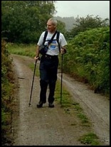 Peter with his walking poles at the ready to assist with the ascent of Midsummer Hill .